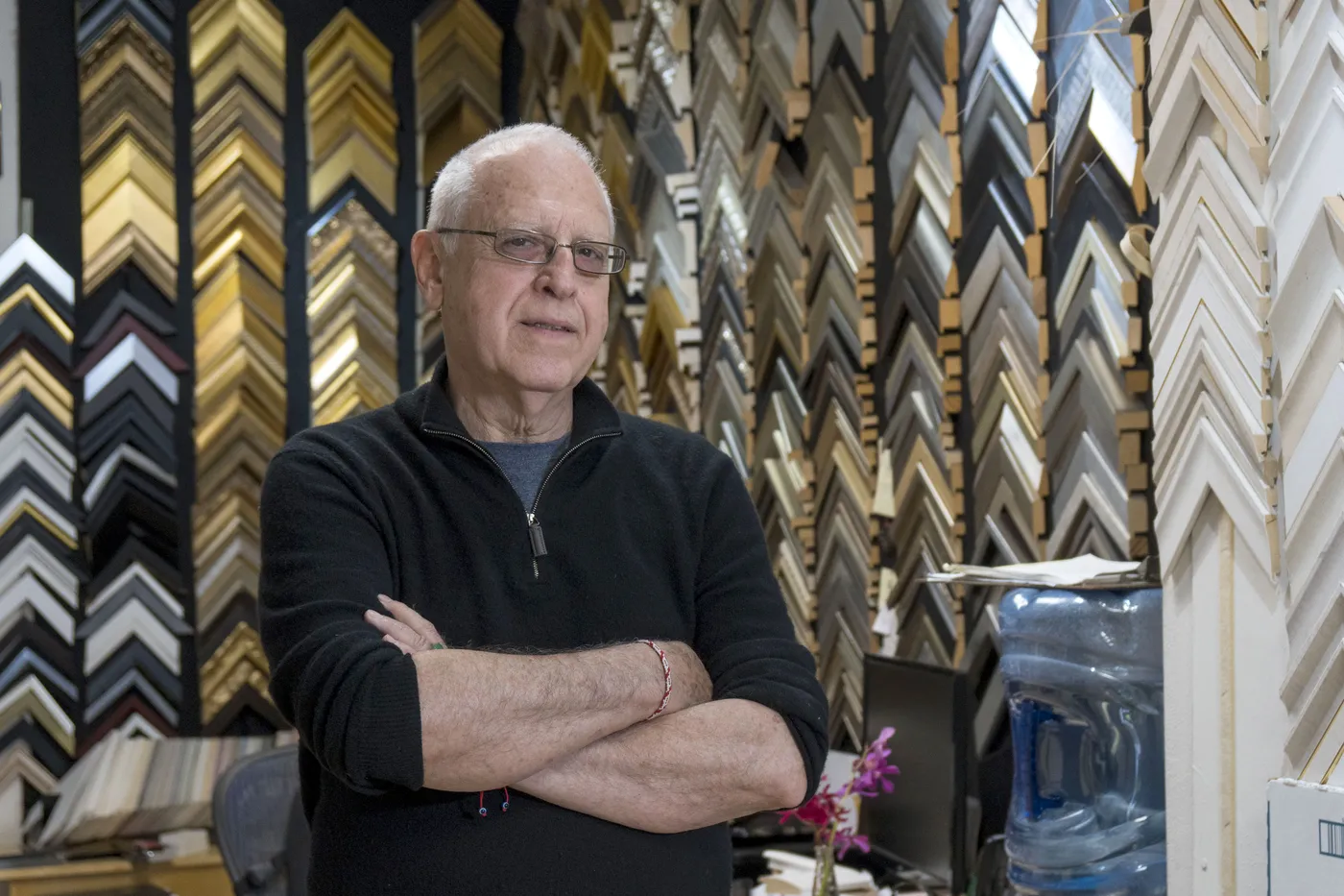 Jadite Gallery founder surrounded by thousands of frame samples in the NYC workshop