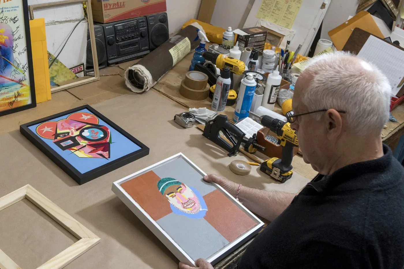 Master framer finishing a custom frame by hand at the workbench